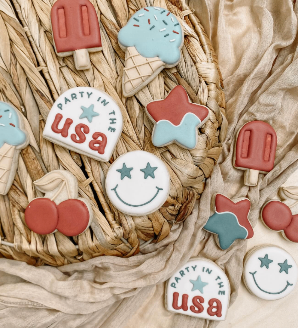 Retro summer cookies in red and blue with popsicles, cherries, smiley face, and stars