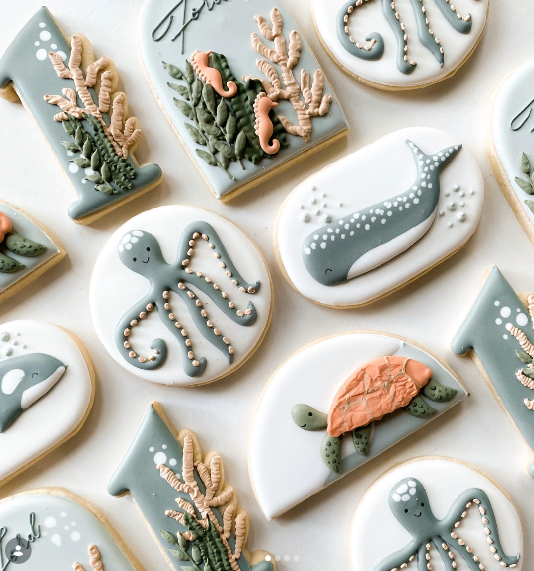 Sea life cookie set in soft coastal blue with octopus, whale, turtle, and coral details